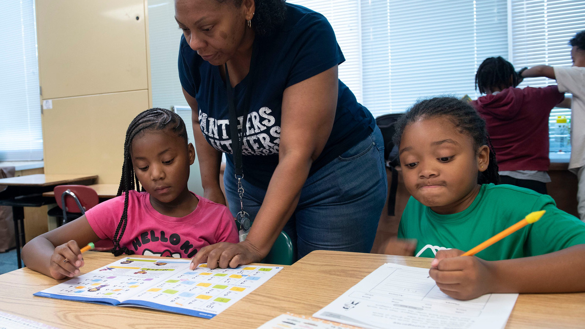Kylani Phillips, and Marleah Smith keep their math skills up to date with help from Montclair Elementary Curriculum Coordinator Shenika Johnson while attending a Boys and Girls Club summer camp program at Montclair on July 1, 2026. Montclair was one of 19 ECPS schools to earn an individual grade of A from the Florida Department of Education for the 2025-26 school year. Three years ago, the elementary school had an F grade. The district overall also earned an A grade for the 2025-26 school year.