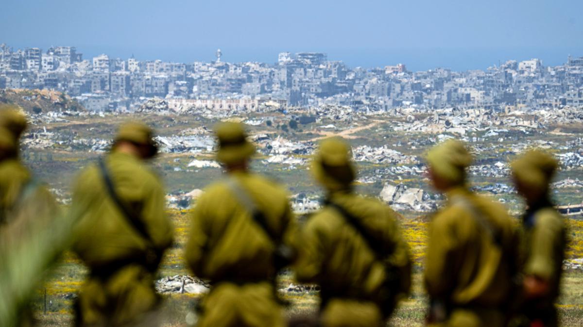 Israeli soldiers looking at the destroyed city of Jabalia, in Gaza Strip, near Kibbutz Nir Am during independence day (Yom Ha'atzmaut) commemorations on April 22, 2026 in Kibbutz Nir Am, Israel.