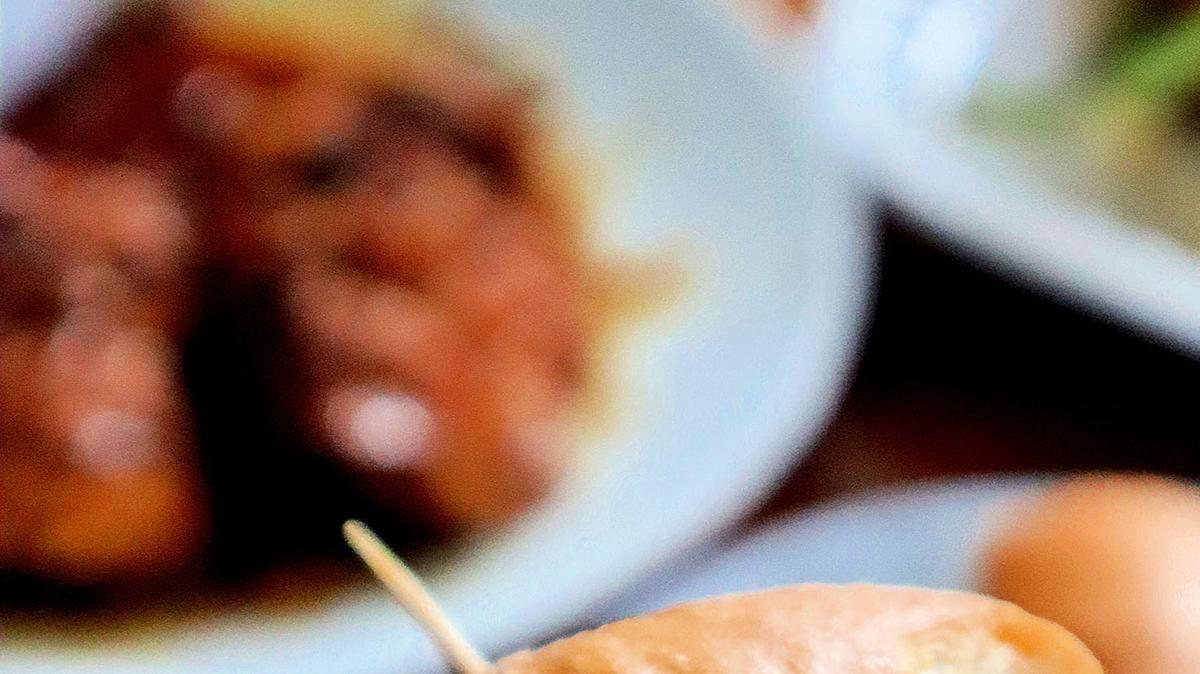 An air-fried chicken sandwich glazed with a glossy sauce made from honey, dark soy and garlic, and topped with cucumber salad.