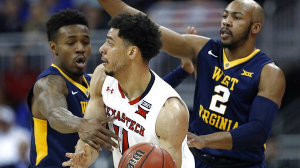 West Virginia's Daxter Miles Jr., left, and Jevon Carter pressure Texas Tech's Zach Smith during the first half of an NCAA college basketball game in the Big 12 men's tournament Friday, March 9, 2018, in Kansas City, Mo.