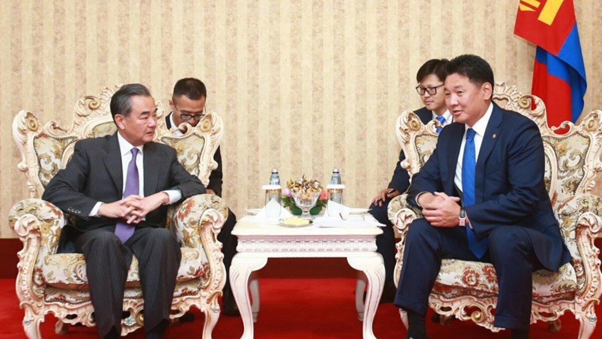 Chinese Foreign Minister Wang Yi (L) and Mongolian Prime Minister Ukhnaa Khurelsukh shake hands during their meeting in Ulan Bator, Mongolia. Photo by BYAMBA-OCHIR / EPA