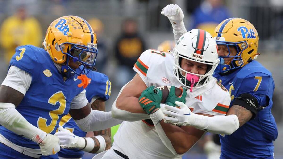  Nov 29, 2025; Pittsburgh, Pennsylvania, USA; Miami Hurricanes tight end Alex Bauman (87) runs after a catch as Pittsburgh Panthers linebacker Rasheem Biles (3) and defensive back Javon McIntyre (7) defend during the third quarter at Acrisure Stadium. Mandatory Credit: Charles LeClaire-Imagn Images | Charles LeClaire-Imagn Images 