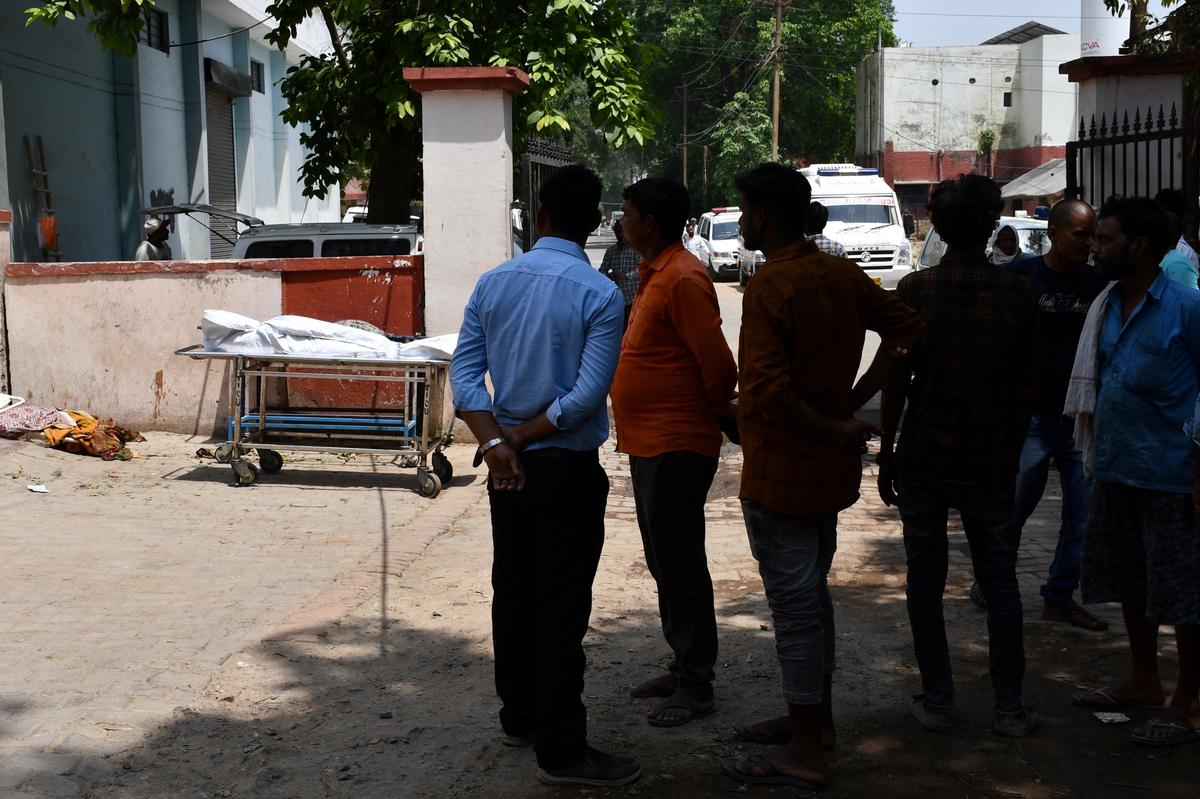 Relatives wait outside of a mortuary at Swaroop Rani Nehru (SRN) Hospital to receive dead bodies of those who lost their lives in heavy storm, in Prayagraj, northern state of Uttar Pradesh, India, May 14, 2026. REUTERS/Stringer