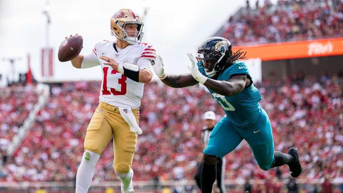  September 28, 2025; Santa Clara, California, USA; San Francisco 49ers quarterback Brock Purdy (13) runs the football against Jacksonville Jaguars linebacker Devin Lloyd (0) during the second quarter at Levi's Stadium. Mandatory Credit: Kyle Terada-Imagn Images | Kyle Terada-Imagn Images 