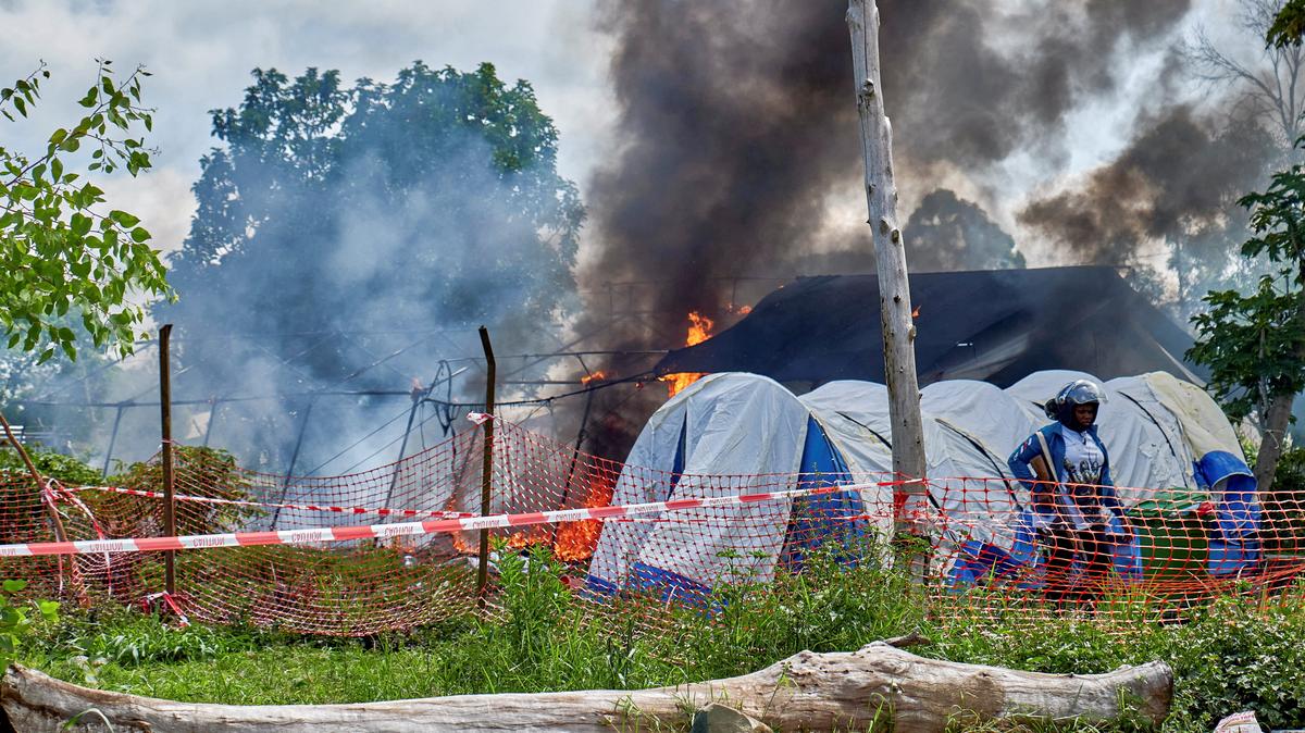 A Congolese police personnel stands guard at the burning Ebola treatment center, as aid agencies intensify efforts to contain a new Ebola outbreak involving the Bundibugyo strain outbreak, in Rwampara general hospital in Rwampara outside Bunia, Ituri province, Democratic Republic of Congo, May 21, 2026. REUTERS/Gradel Muyisa Mumbere