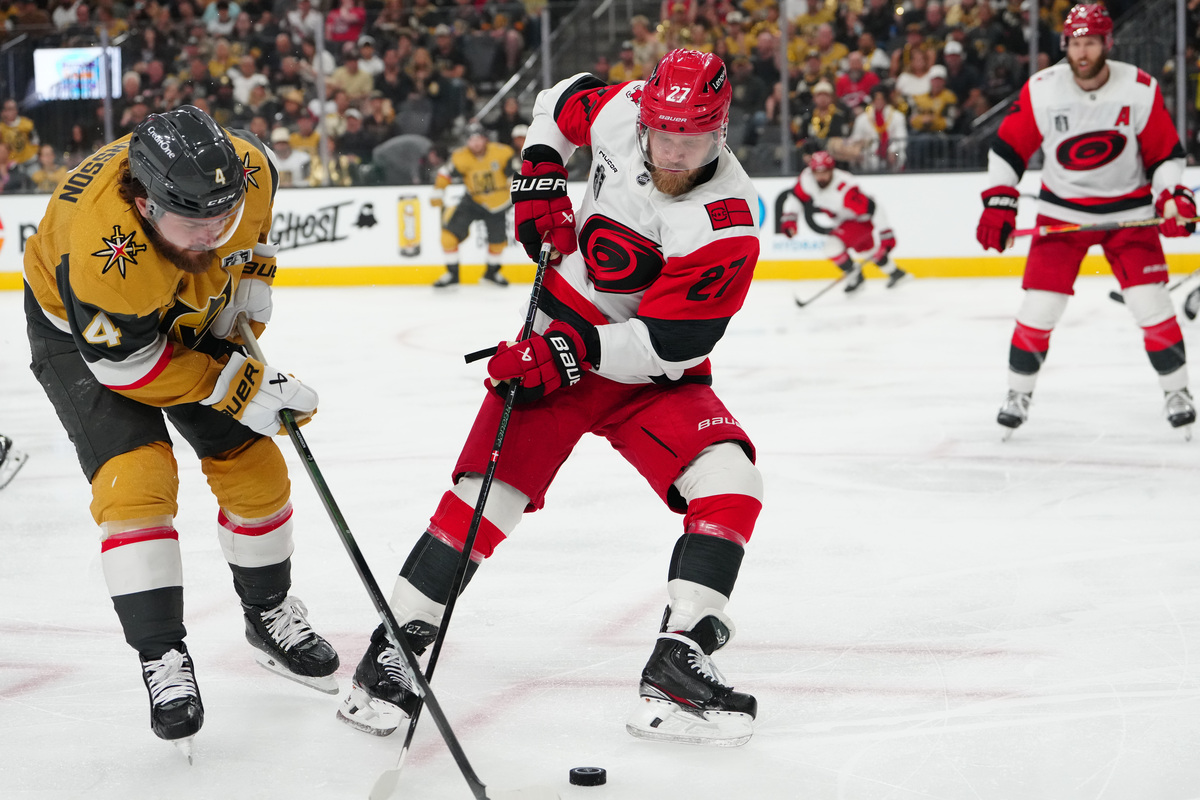 Jun 14, 2026; Las Vegas, Nevada, USA; Vegas Golden Knights defenseman Rasmus Andersson (4) battles for the puck against Carolina Hurricanes left wing Nikolaj Ehlers (27) during the third period in game six of the 2026 Stanley Cup Final at T-Mobile Arena. Mandatory Credit: Stephen R. Sylvanie-Imagn Images