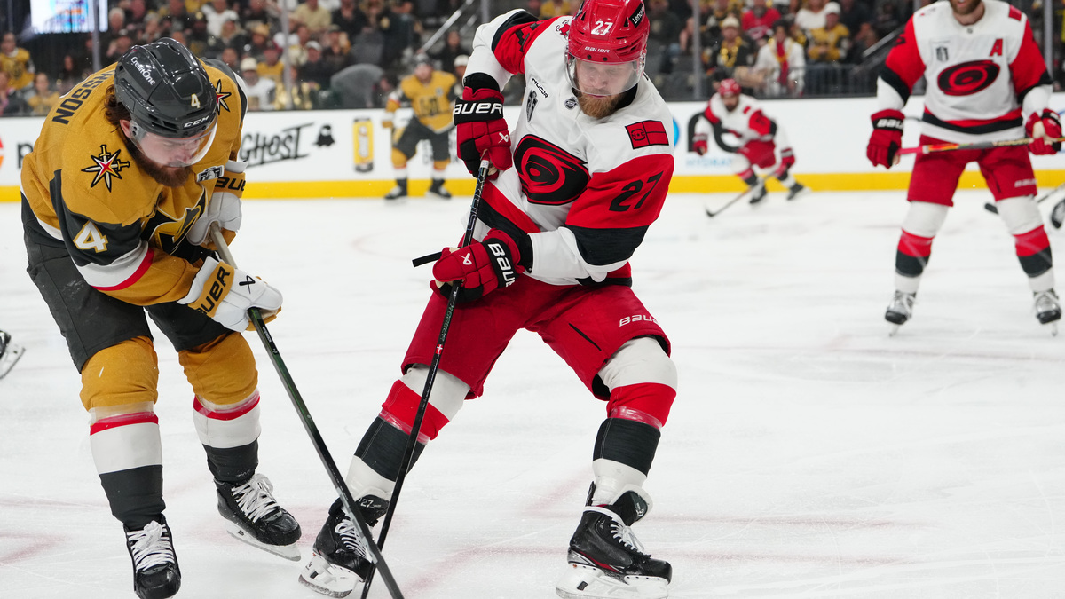 Jun 14, 2026; Las Vegas, Nevada, USA; Vegas Golden Knights defenseman Rasmus Andersson (4) battles for the puck against Carolina Hurricanes left wing Nikolaj Ehlers (27) during the third period in game six of the 2026 Stanley Cup Final at T-Mobile Arena. Mandatory Credit: Stephen R. Sylvanie-Imagn Images