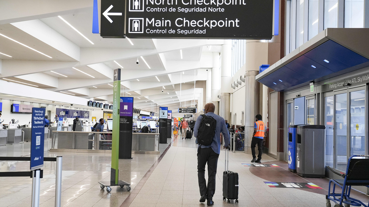 Travelers move through the airport while lines remain at a minimum at Atlanta Hartsfield-Jackson International Airport on March 28, 2026, in Atlanta.