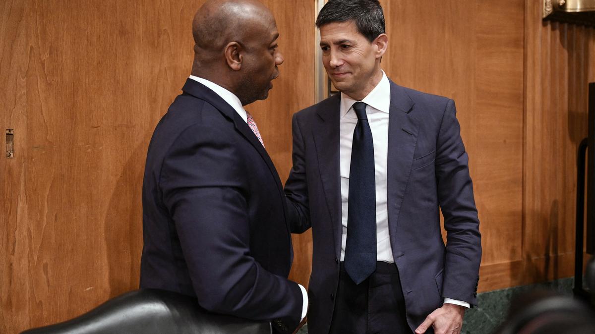 Kevin Warsh (right), nominee for U.S. Federal Reserve Chair, speaks with committee chairman U.S. Senator Tim Scott, Republican from South Carolina, at the end of a Senate Banking Committee hearing on Warsh's nomination on Capitol Hill in Washington, D.C., on April 21, 2026. (Mandel Ngan/AFP/Getty Images/TNS)