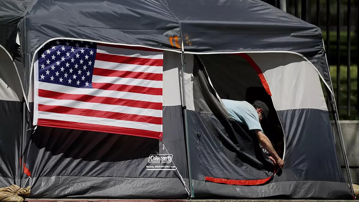 American flags decorate tents at an encampment of homeless veterans along San Vicente Boulevard in Brentwood in 2020. State lawmakers are considering expanding property tax breaks for disabled veterans in part to help prevent them from becoming homeless. (Luis Sinco/Los Angeles Times/TNS)