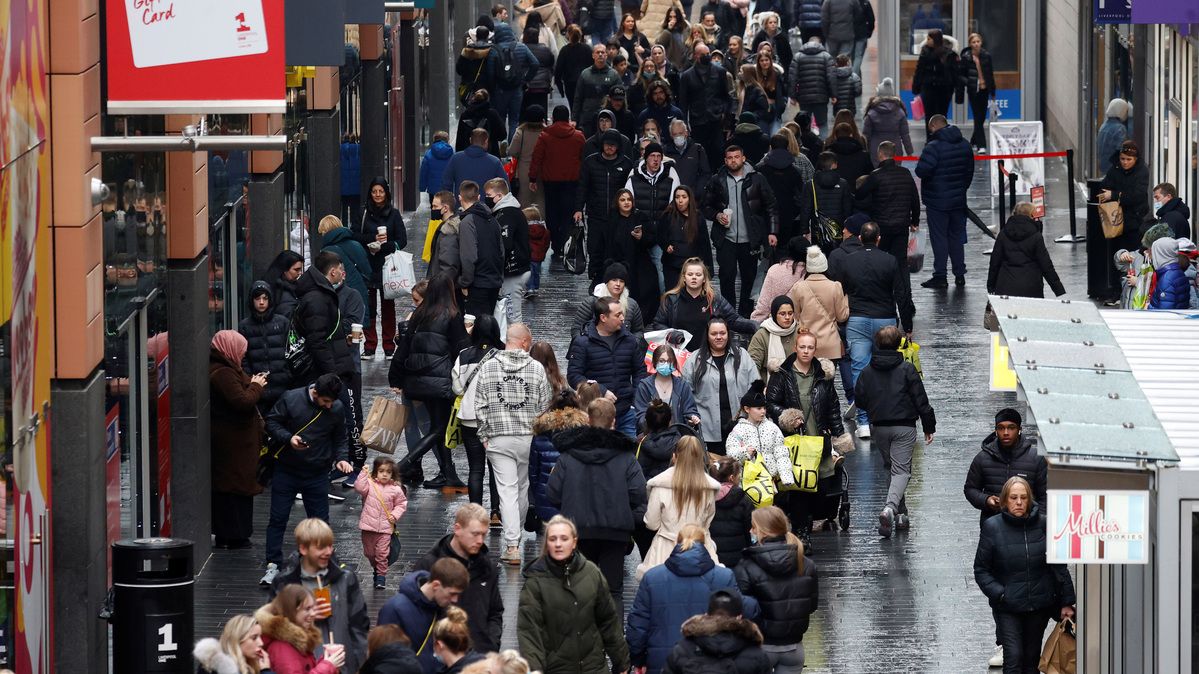 People walk along a busy shopping street in Liverpool, Britain, December 26 , 2021. REUTERS/Phil Noble