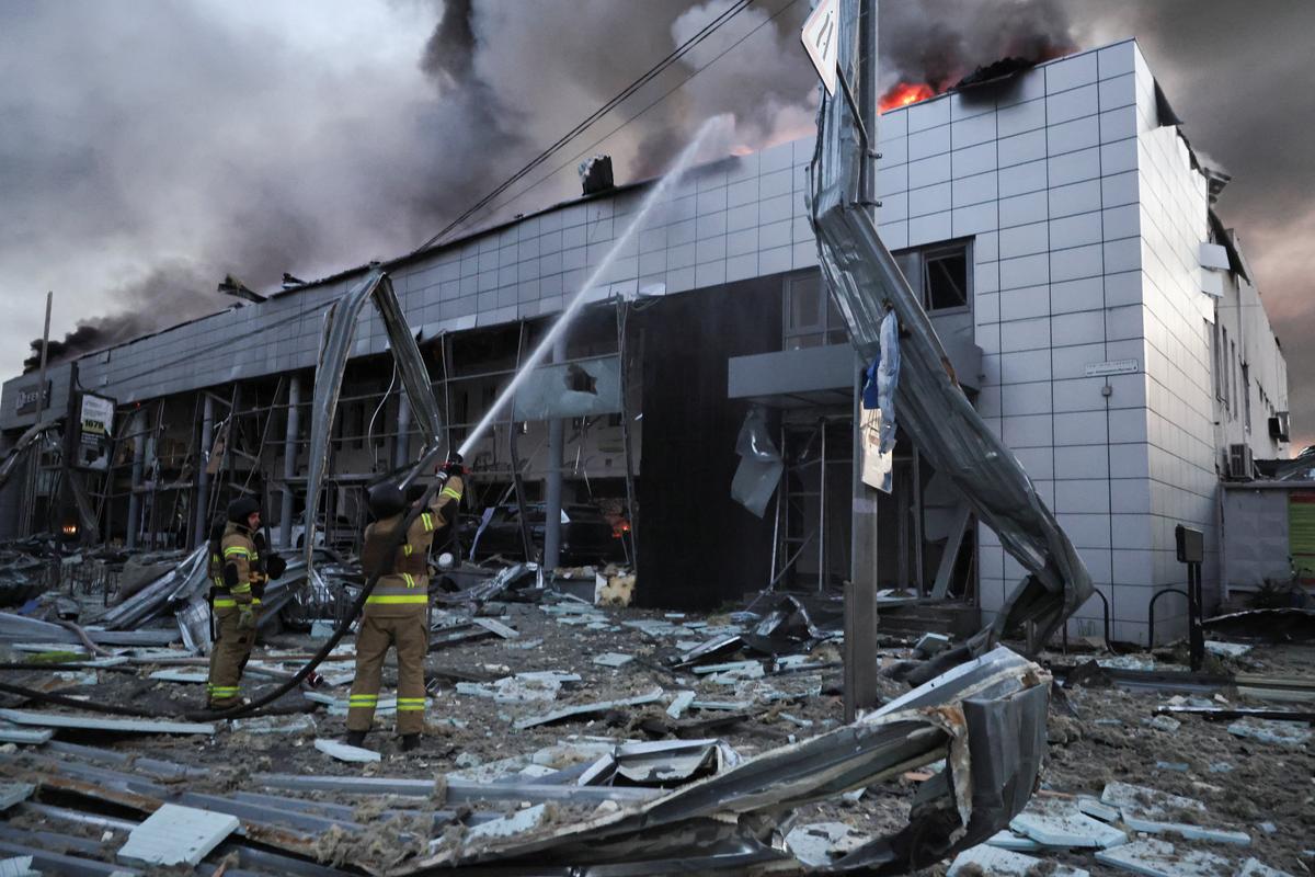 Firefighters work at a car dealership damaged during Russian missile and drone strikes, amid Russia's attack on Ukraine, in Kyiv, Ukraine, June 2, 2026. REUTERS/Thomas Peter
