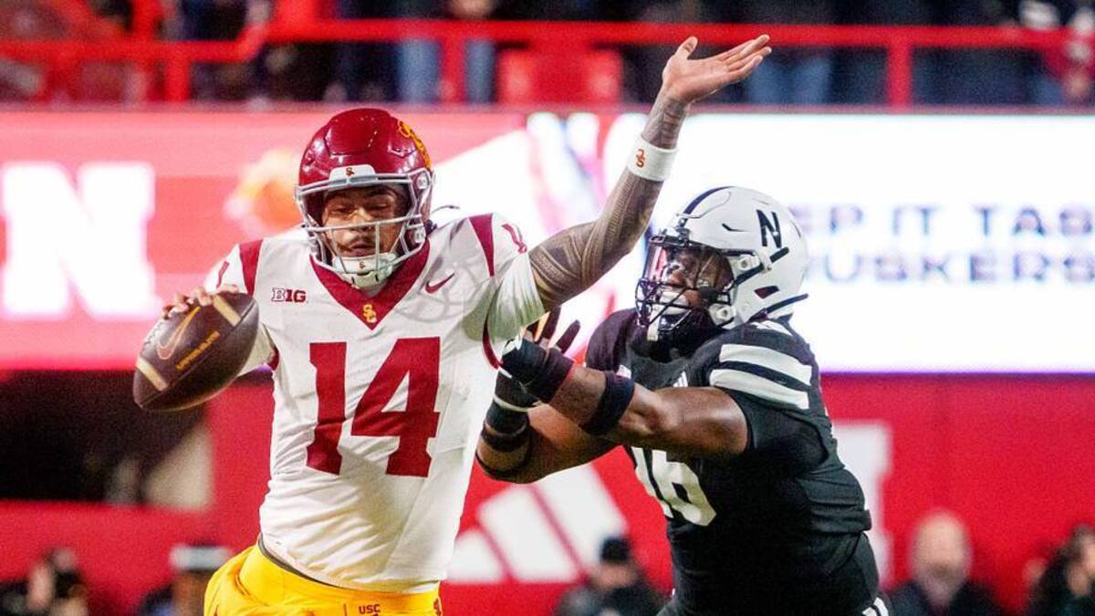  Nov 1, 2025; Lincoln, Nebraska, USA; Southern California Trojans quarterback Jayden Maiava (14) runs against Nebraska Cornhuskers defensive lineman Elijah Jeudy (16) during the second quarter at Memorial Stadium. Mandatory Credit: Dylan Widger-Imagn Images | Dylan Widger-Imagn Images 