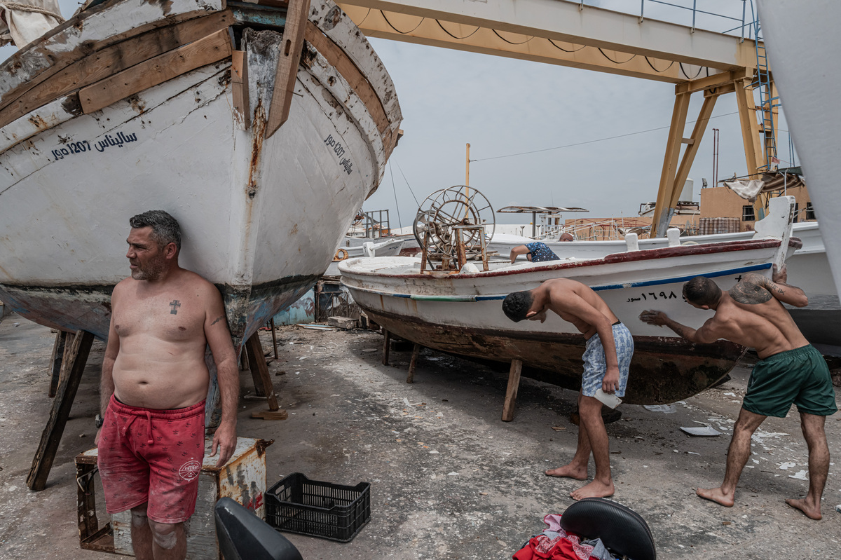 FILE -- Fishermen repairing a boat in the aftermath of an Israeli airstrike in Tyre, in southern Lebanon, on May 2, 2026. The war with Iran has shaken trust in the Middle East's peace, stability and prosperity. (Daniel Berehulak/The New York Times)