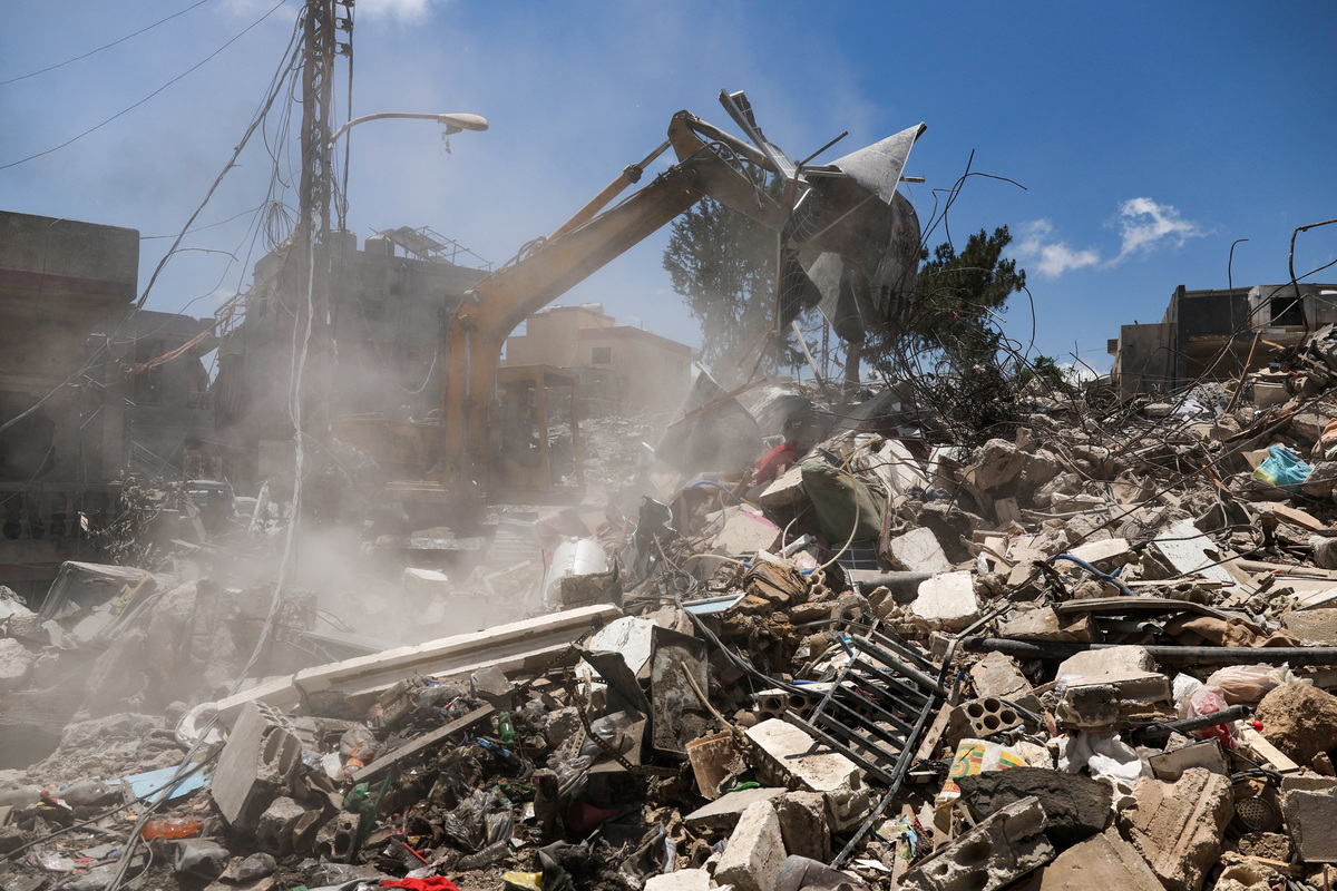 A machine clears debris in a neighborhood heavily damaged by an Israeli airstrike, following the U.S.–Iran deal, in Qlailieh, Tyre district, Lebanon, June 18, 2026. REUTERS/Zohra Bensemra