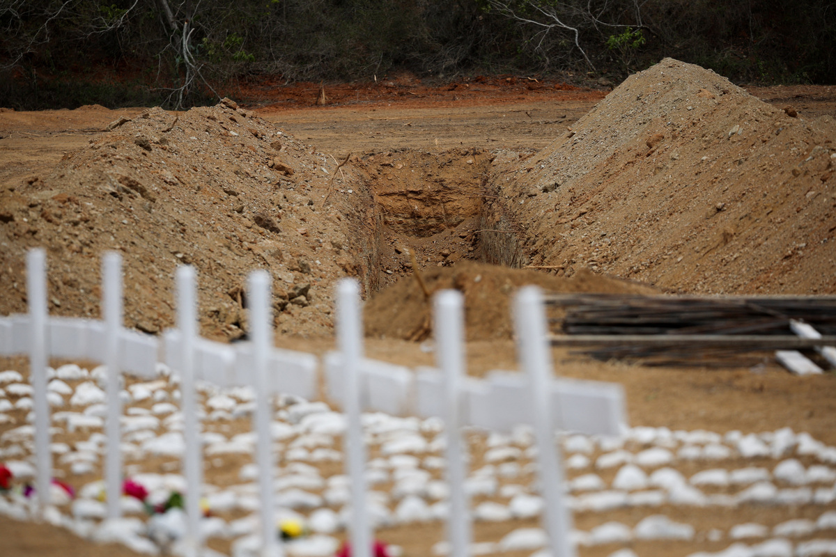 A view of freshly dug up graves on the day of the burial of earthquake victims, in the aftermath of the June 24 earthquakes, at La Esperanza Cemetery, in La Guaira, Venezuela, July 6, 2026. REUTERS/Adriano Machado
