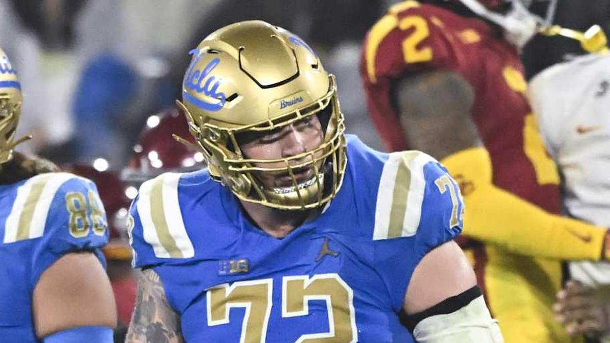  Nov 23, 2024; Pasadena, California, USA; UCLA Bruins tight end Moliki Matavao (88) and UCLA Bruins offensive lineman Garrett DiGiorgio (72) walks off the field USC Trojans head coach Lincoln Riley (far left) and bench celebrates in the closing minute at Rose Bowl. Mandatory Credit: Robert Hanashiro-Imagn Images | Robert Hanashiro-Imagn Images 
