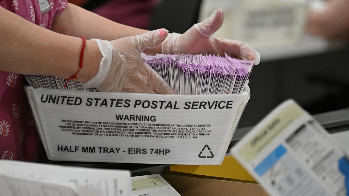 Election workers prepare mail-in ballots for tallying at the Los Angeles County Ballot Processing Center on the eve of Election Day, Nov. 4, 2024, in City of Industry, California. (Robyn Beck/AFP via Getty Images/TNS)