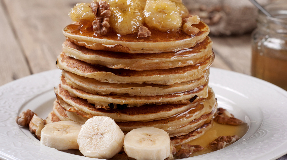Pancake with caramelized bananas, nuts and honey. Copy space. Selective focus
