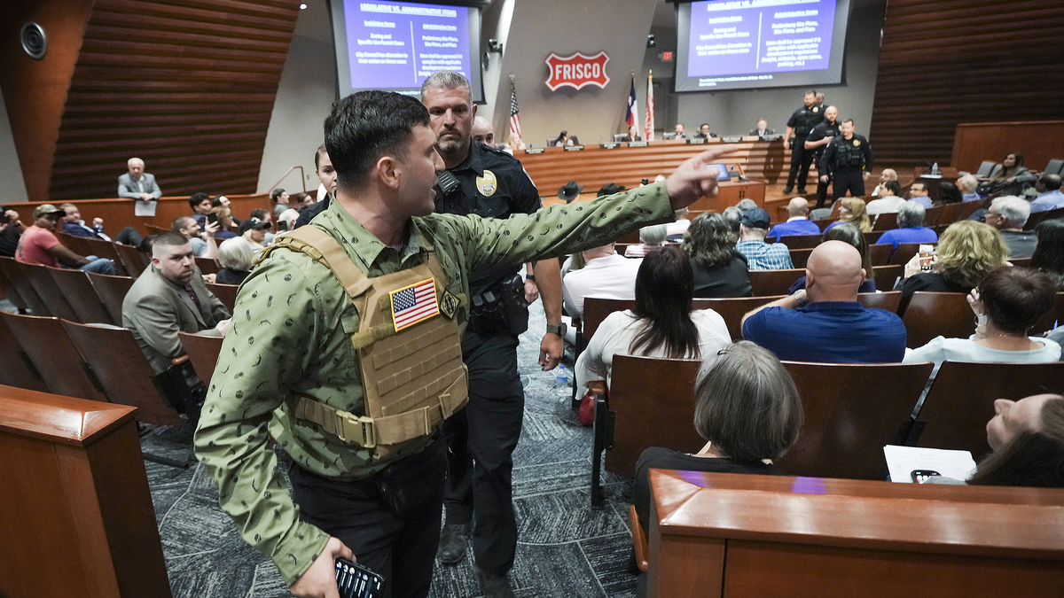 Jake Lang is removed by police for violating decorum rules while speaking in opposition to the proposed construction of a mosque and two temples during a city council meeting in Frisco, Texas, Tuesday, May 19, 2026. (Smiley N. Pool/The Dallas Morning News/TNS)
