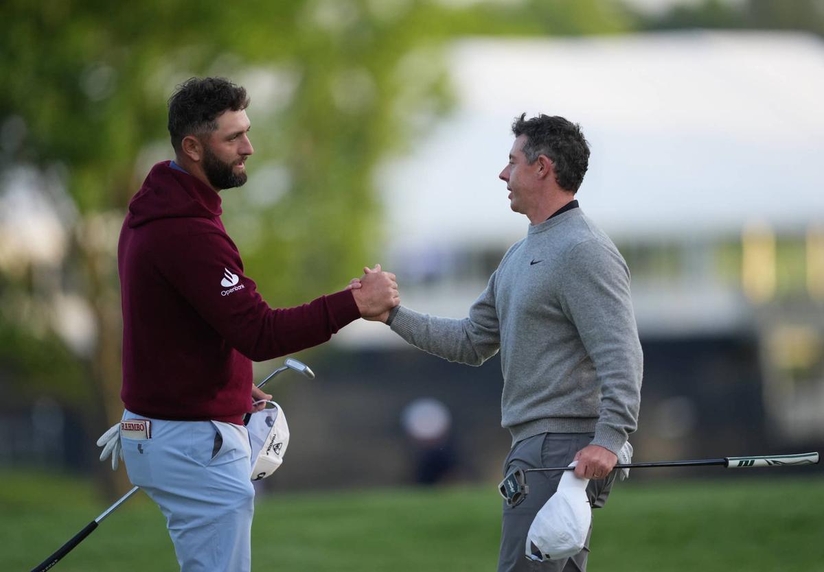  May 15, 2026; Newtown Square, Pennsylvania, USA; Rory McIlroy shakes hands with Jon Rahm (left) after the second round of the PGA Championship golf tournament. Mandatory Credit: James Lang-Imagn Images 