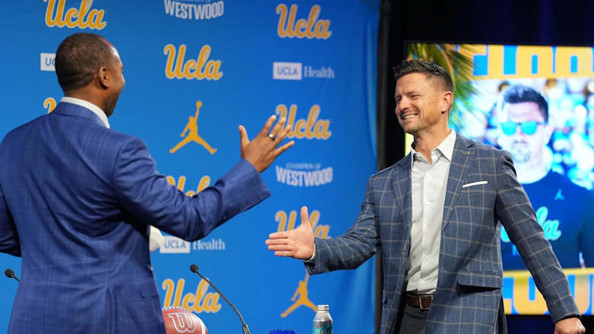  Dec 9, 2025; Los Angeles, CA, USA; UCLA football coach Bob Chesney (right) shakes hands with athletic director Martin Jarmond at introductory press conference at Renee Luskin Conference Center Centennial Ballroom. Mandatory Credit: Kirby Lee-Imagn Images | Kirby Lee-Imagn Images 
