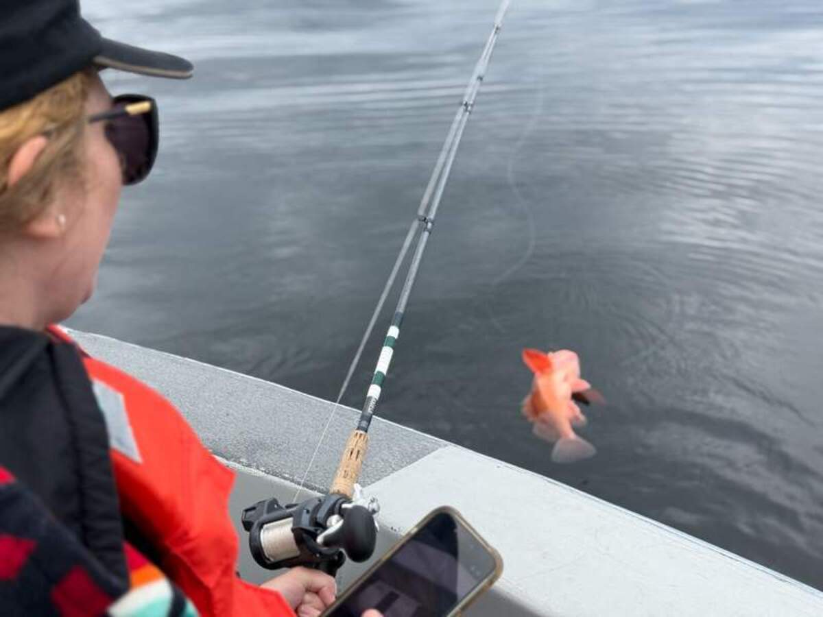  Megan fishing from a skiff. Photo credit: Mimi Slawoff 