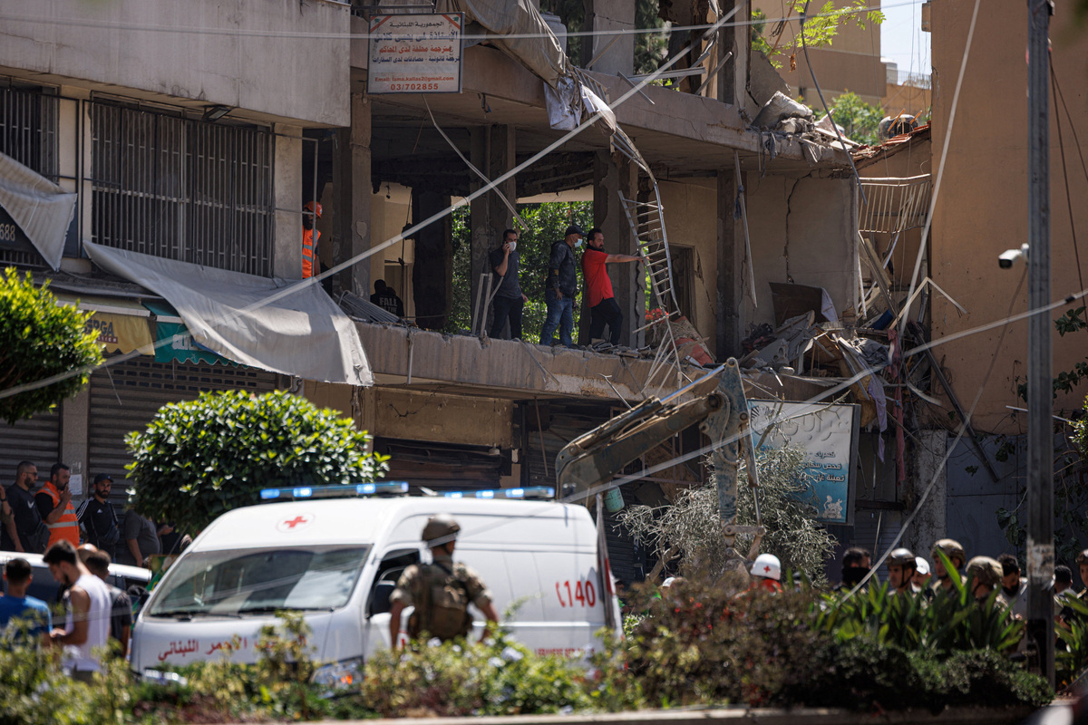 A Lebanese army officer stands as police officers and emergency personnel work at the site of an Israeli strike on the southern suburbs of Beirut, Lebanon, June 14, 2026. REUTERS/Zohra Bensemra