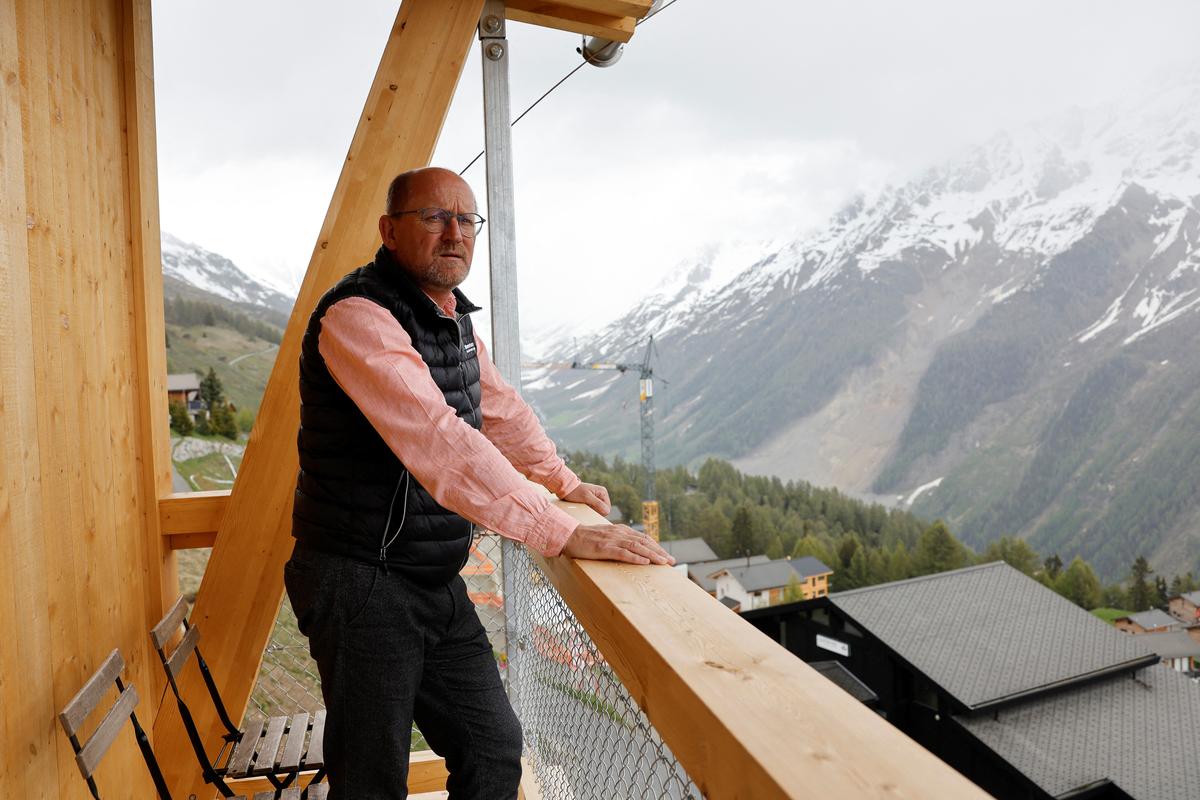 Lukas Kalbermatten poses at the newly built Momentum Lodge at the Lauchernalp in Wiler, nearly a year after a massive rock and ice slide triggered by the collapse of the Birch Glacier destroyed much of the village of Blatten, Switzerland, May 20, 2026.  REUTERS/Stefan Wermuth