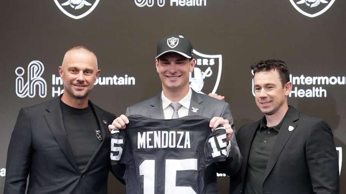  Apr 24, 2026; Henderson, NV, USA; Las Vegas Raiders quarterback Fernando Mendoza (center) poses with jersey with general manager John Spytek (left) and head coach Klint Kubiak at introductory press conference at Intermountain Health Performance Center after being selected as the No. 1 pick in the 2026 NFL Draft. Mandatory Credit: Kirby Lee-Imagn Images | Kirby Lee-Imagn Images 