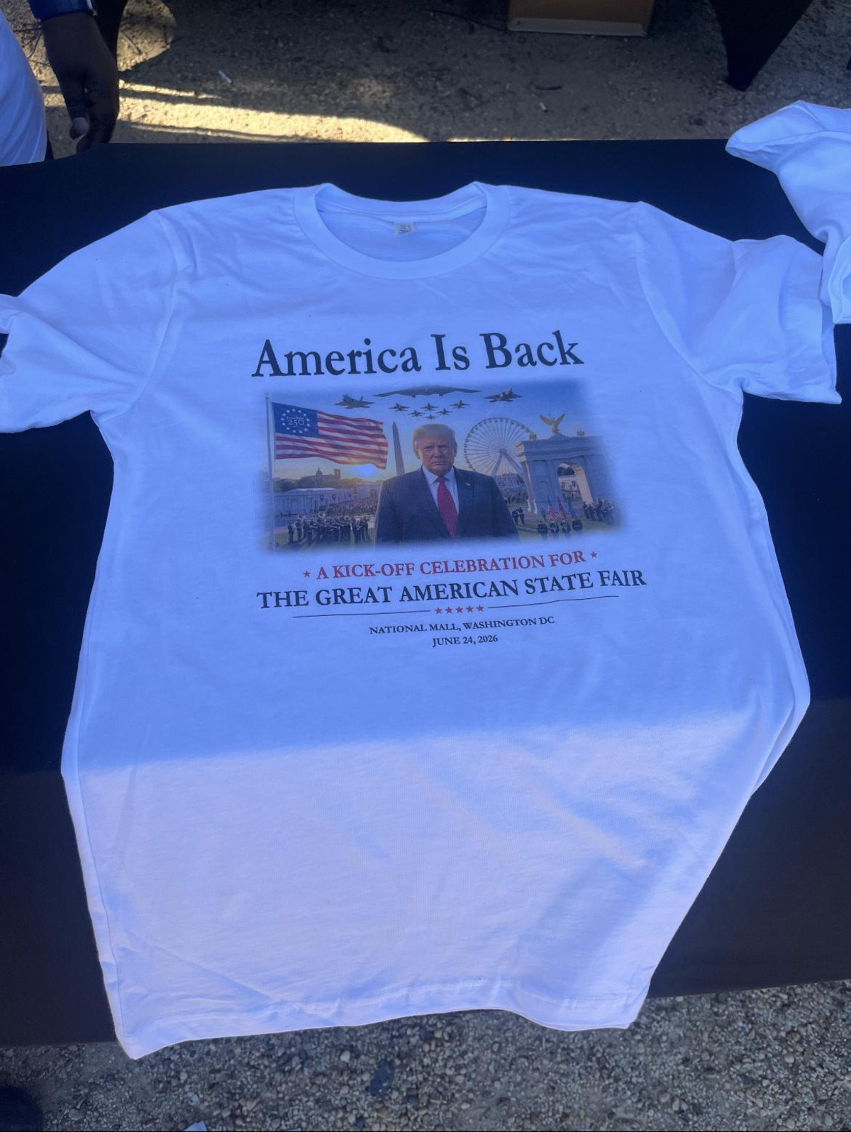 Shirts sold at President Donald Trump's Great American State Fair rally featured his face, Freedom 250 flags and the fairgrounds.