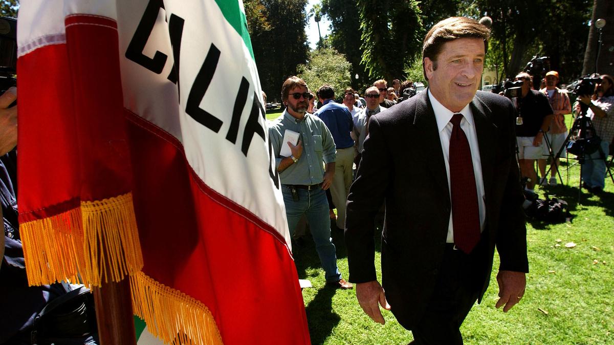 Then-Insurance Commissioner John Garamendi, a Democrat, walks past the California state flag to the podium just before a news conference at the State Capital in Sacramento, California. (David Paul Morris/Getty Images/TNS)
