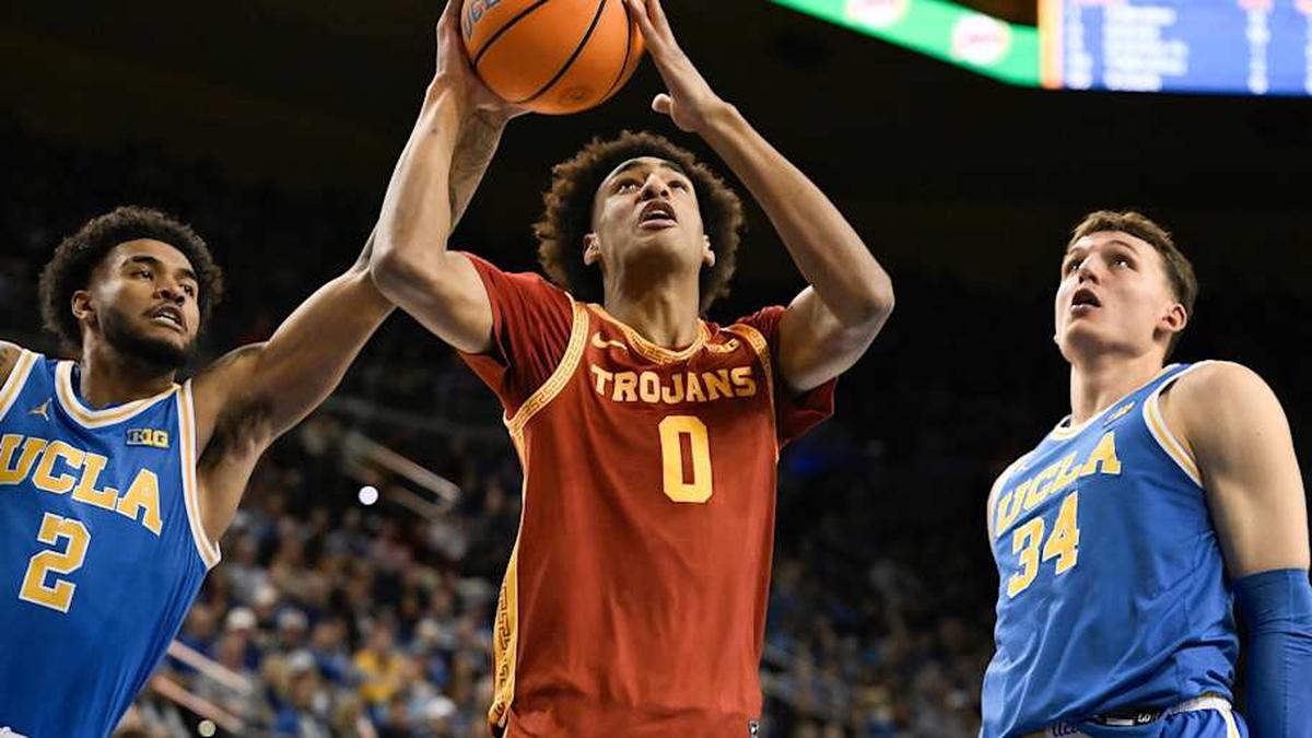  Feb 24, 2026; Los Angeles, California, USA; Southern California Trojans guard Alijah Arenas (0) drives to the basket past UCLA Bruins guard Donovan Dent (2) and forward Tyler Bilodeau (34) during the first half at Pauley Pavilion presented by Wescom Financial. Mandatory Credit: Robert Hanashiro-Imagn Images | Robert Hanashiro-Imagn Images 