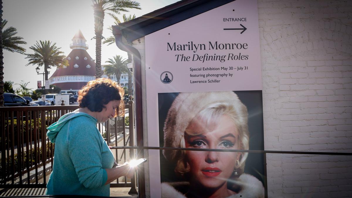 A guestwalks to an exhibit of Pop icon Marilyn Monroe, during a media night preview of Marilyn Monroe: The Defining Roles, at the Ice House Museum at the Hotel Del Coronado on Friday, May 29, 2026. The exhibit is celebrating her 100th birthday and will run from May 30th through July 31st.   (Photo by Sandy Huffaker for The San Diego Union-Tribune)