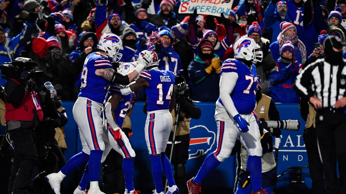 Buffalo Bills running back Devin Singletary, second from left, celebrates his touchdown with his teammates during the first half of an NFL wild-card playoff football game against the New England Patriots, Saturday, Jan. 15, 2022, in Orchard Park, N.Y. (AP Photo/Adrian Kraus)