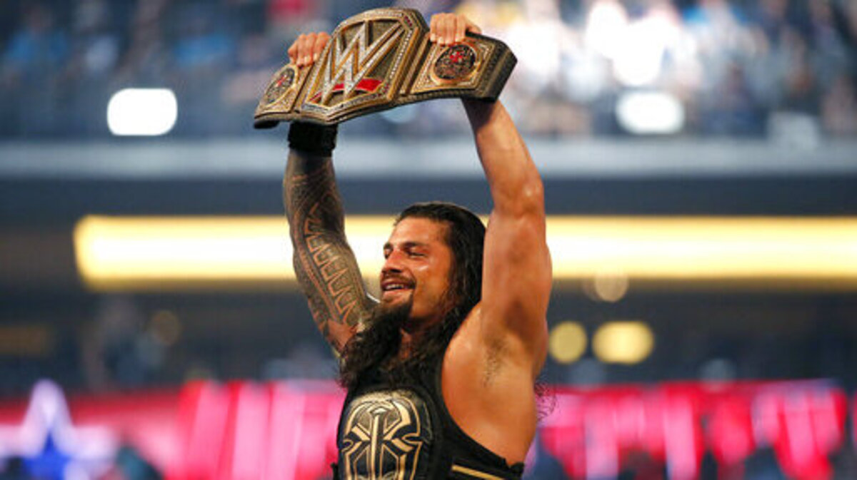 In this file photo, Roman Reigns holds up a championship belt during WrestleMania 32 in Arlington on April 3, 2016. Reigns is expected to be among the superstars featured in “WWE Friday Night SmackDown” on Friday, July 8 at Dickies Arena in Fort Worth.