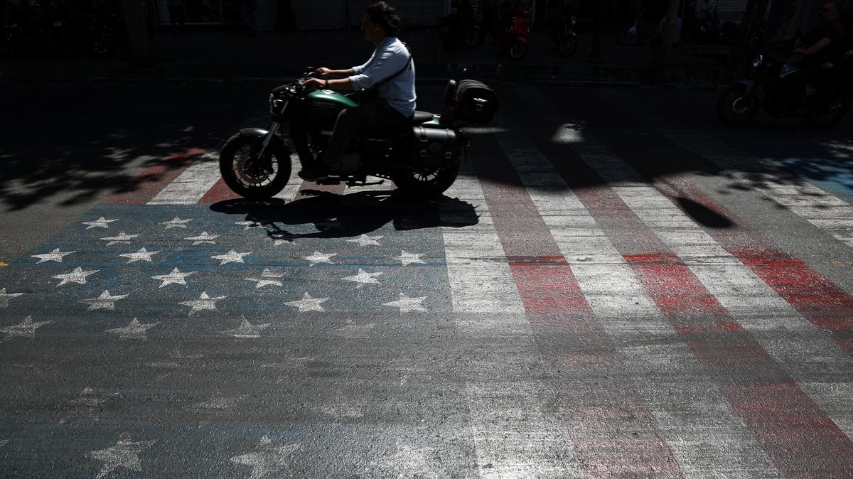A person rides a motorcycle over a U.S. flag painted on a street, in Tehran, Iran, May 12, 2026. Majid Asgaripour/WANA (West Asia News Agency) via REUTERS ATTENTION EDITORS - THIS PICTURE WAS PROVIDED BY A THIRD PARTY