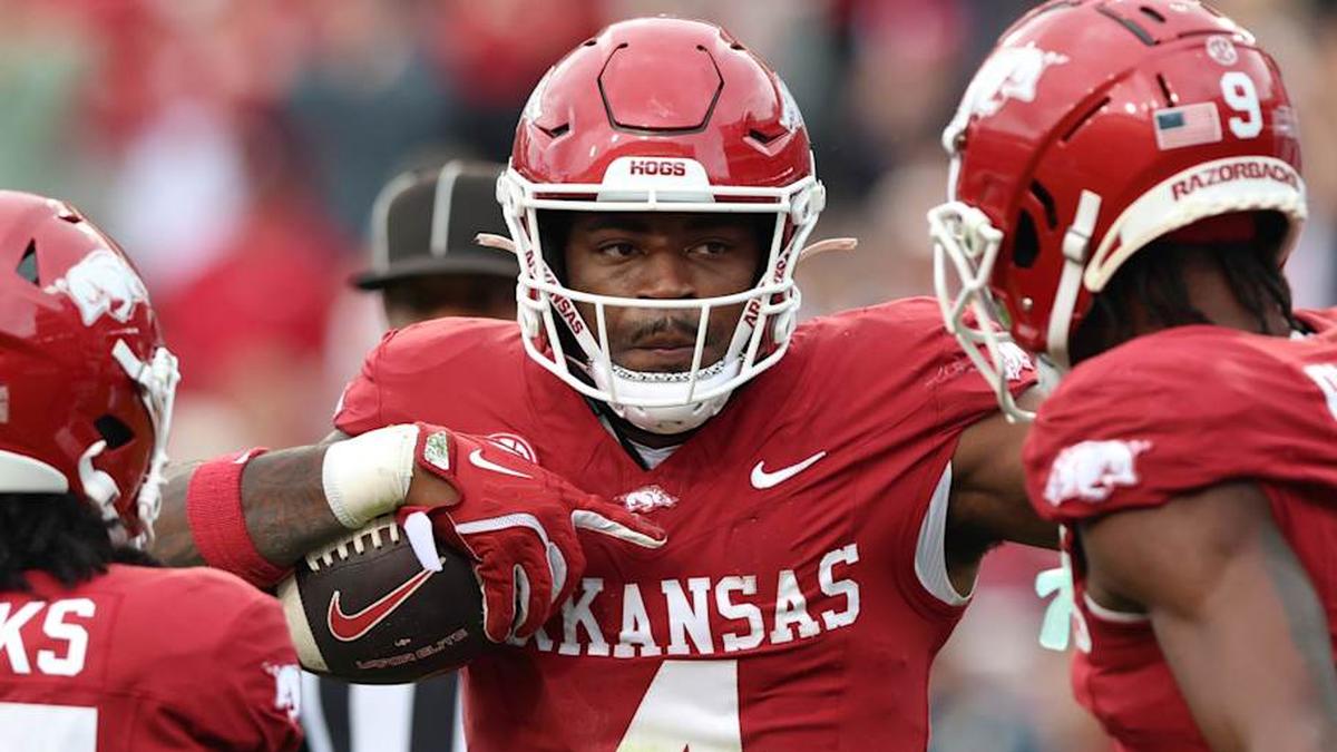  Oct 18, 2025; Fayetteville, Arkansas, USA; Arkansas Razorbacks running back Mike Washington Jr (4) celebrates with teammates after rushing for a first down in the second quarter against the Texas A&M Aggies at Donald W. Reynolds Razorback Stadium. Mandatory Credit: Nelson Chenault-Imagn Images | Nelson Chenault-Imagn Images 
