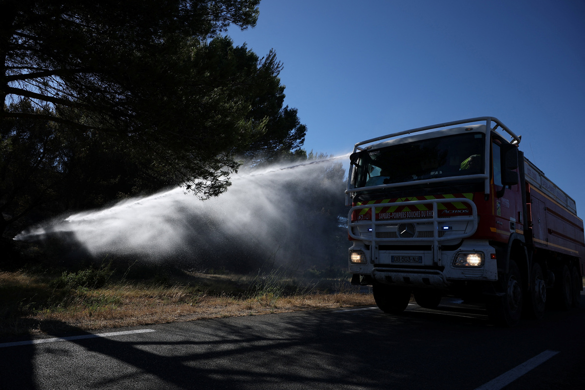 A fire truck sprays water to contain a wildfire in Lancon-Provence near Marseille, France, July 2, 2026. REUTERS/Manon Cruz