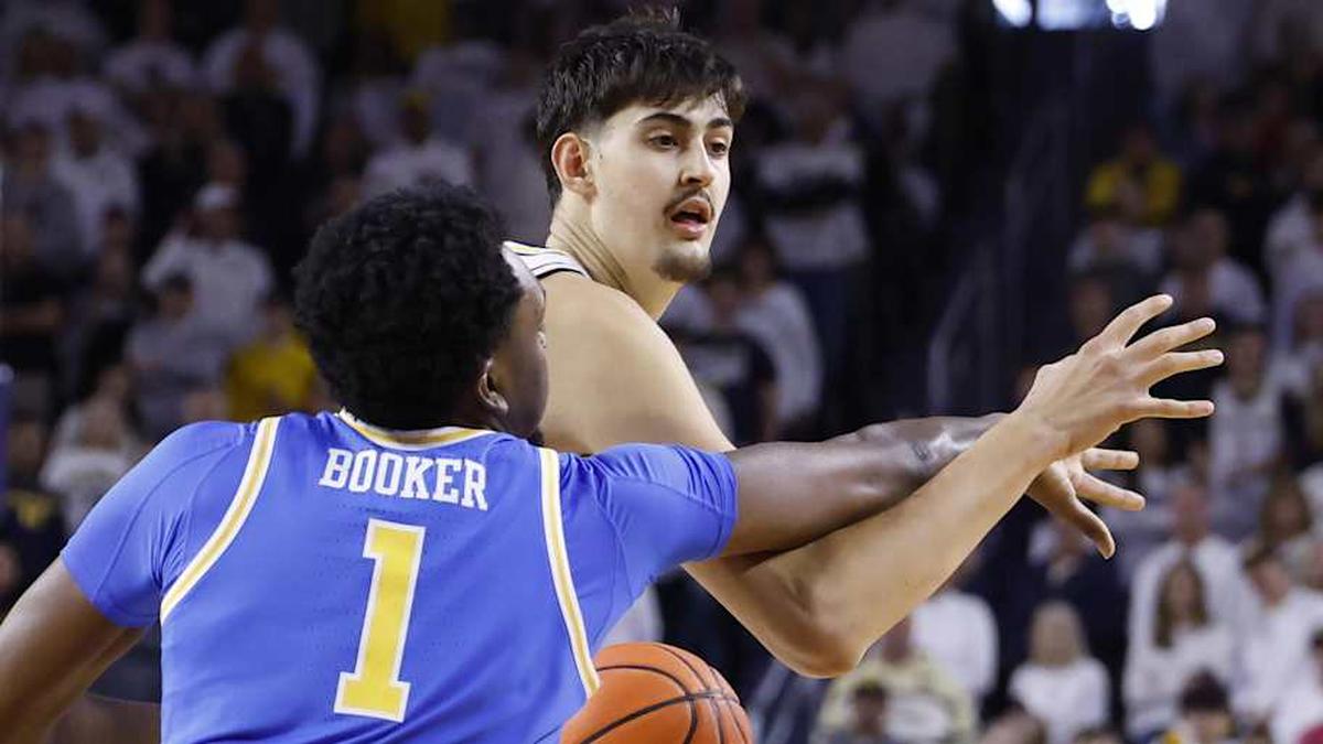  Feb 14, 2026; Ann Arbor, Michigan, USA; Michigan Wolverines center Aday Mara (15) is defended by UCLA Bruins forward Xavier Booker (1) in the first half at Crisler Center. Mandatory Credit: Rick Osentoski-Imagn Images | Rick Osentoski-Imagn Images 