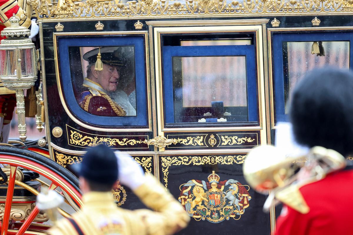 Britain's King Charles and Queen Camilla sit in a carriage, on the day of the State Opening of Parliament in London, Britain, May 13, 2026. REUTERS/Toby Shepheard
