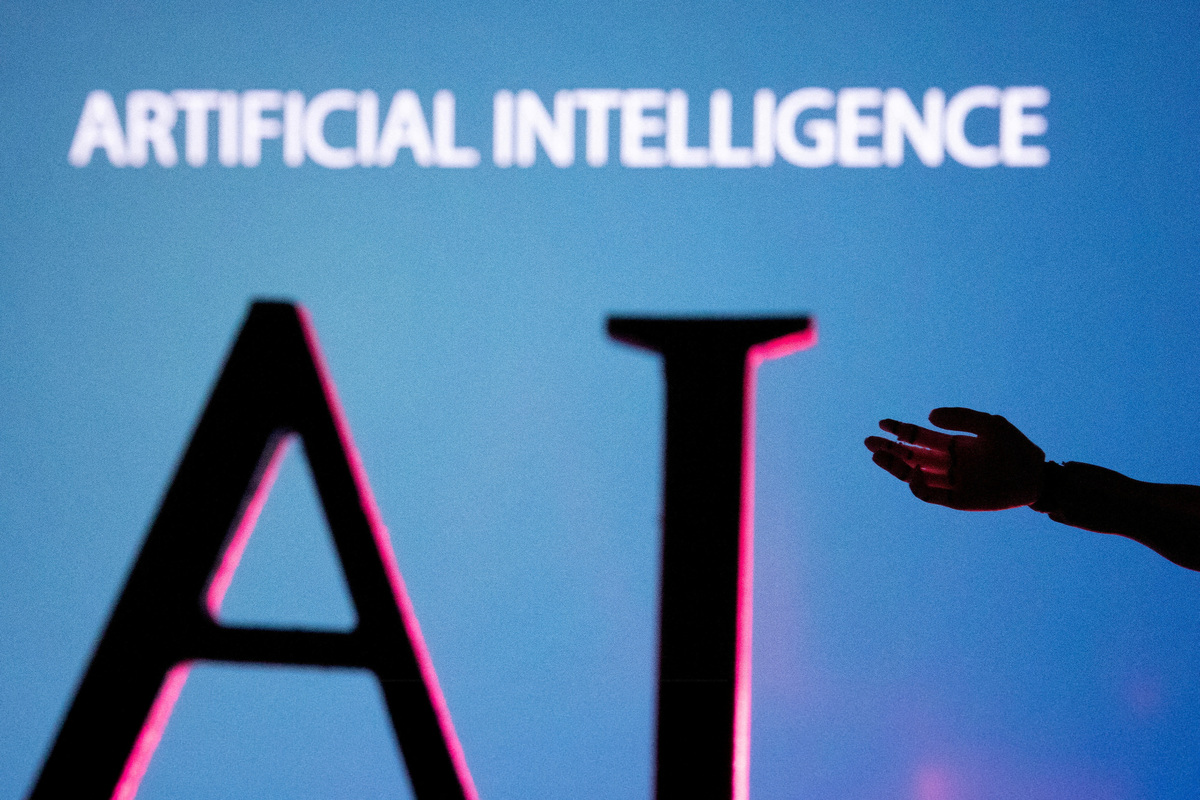 FILE PHOTO: AI (Artificial Intelligence) letters and robot hand miniature in this illustration taken, June 23, 2023. REUTERS/Dado Ruvic/Illustration