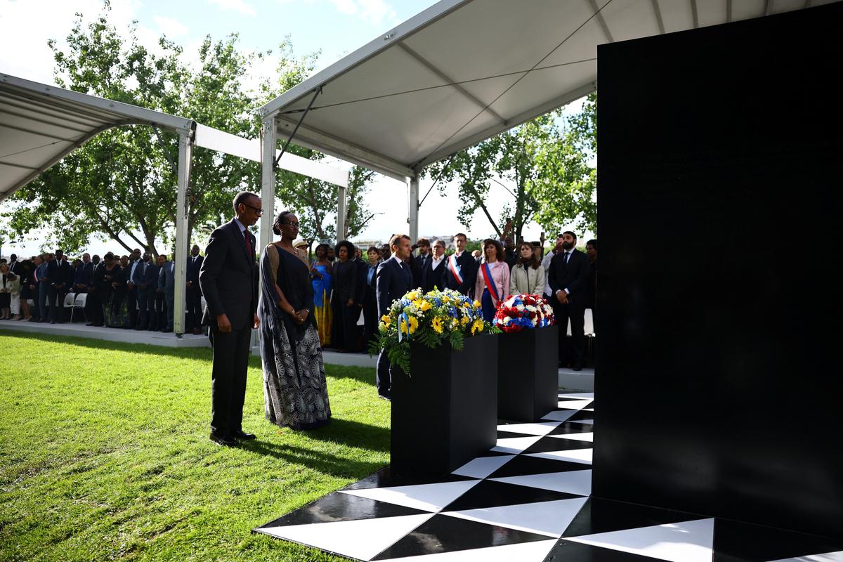 French President Emmanuel Macron, Rwandan President Paul Kagame and Rwanda's First Lady Jeannette Kagame stand at attention after laying wreaths of flowers during the inauguration ceremony of a double stele artwork by artist Grada Kilomba, a new memorial site paying tribute to the victims of the Rwanda's genocide at the Habib-Bourgiba esplanade along the River Seine, in Paris, France, June 2, 2026. REUTERS/Sarah Meyssonnier/Pool