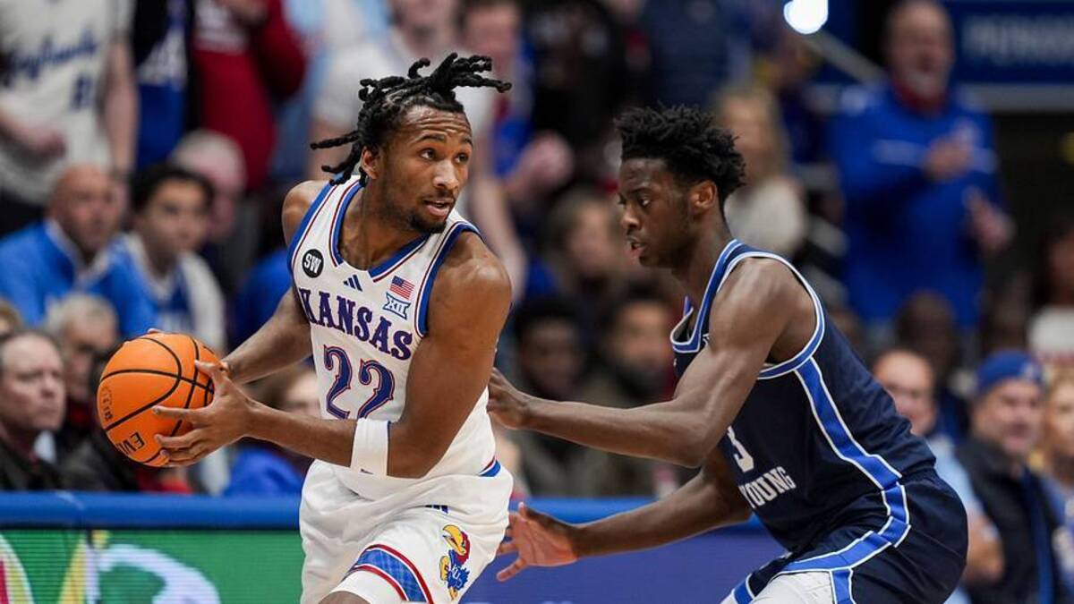  Kansas guard Darryn Peterson looks to pass against BYU forward AJ Dybantsa during their Big 12 matchup in January. | Jay Biggerstaff-Imagn Images 