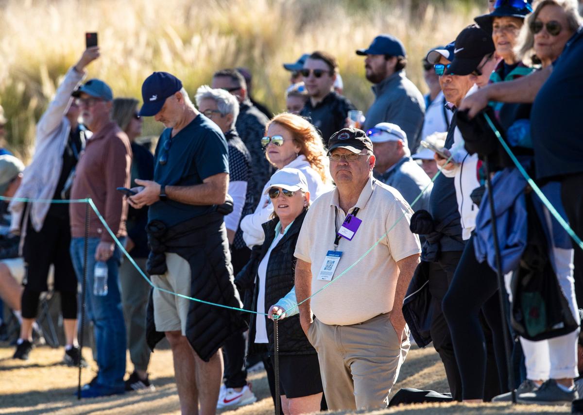 Golf reporter Larry Bohannan of The Desert Sun watches Jon Rahm and Rickie Fowler on the fairway of hole 10 of the Nicklaus Tournament Course at PGA West in La Quinta, Calif., Friday, Jan. 20, 2023.