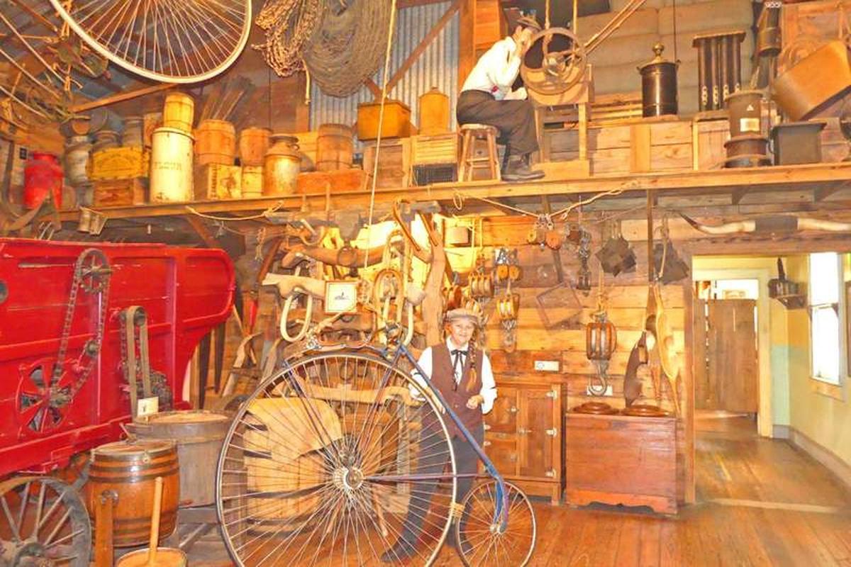  Our "sales-person" shows us the penny-farthing bicycle. Photo credit: Kathleen Walls 