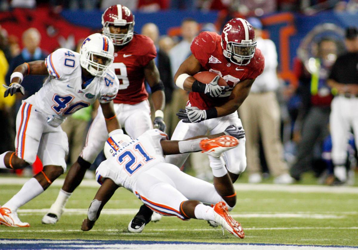  Alabama Crimson Tide running back Mark Ingram breaks away from Florida Gators safety Major Wright during the 2009 SEC championship game at the Georgia Dome. John David Mercer-USA TODAY Sports