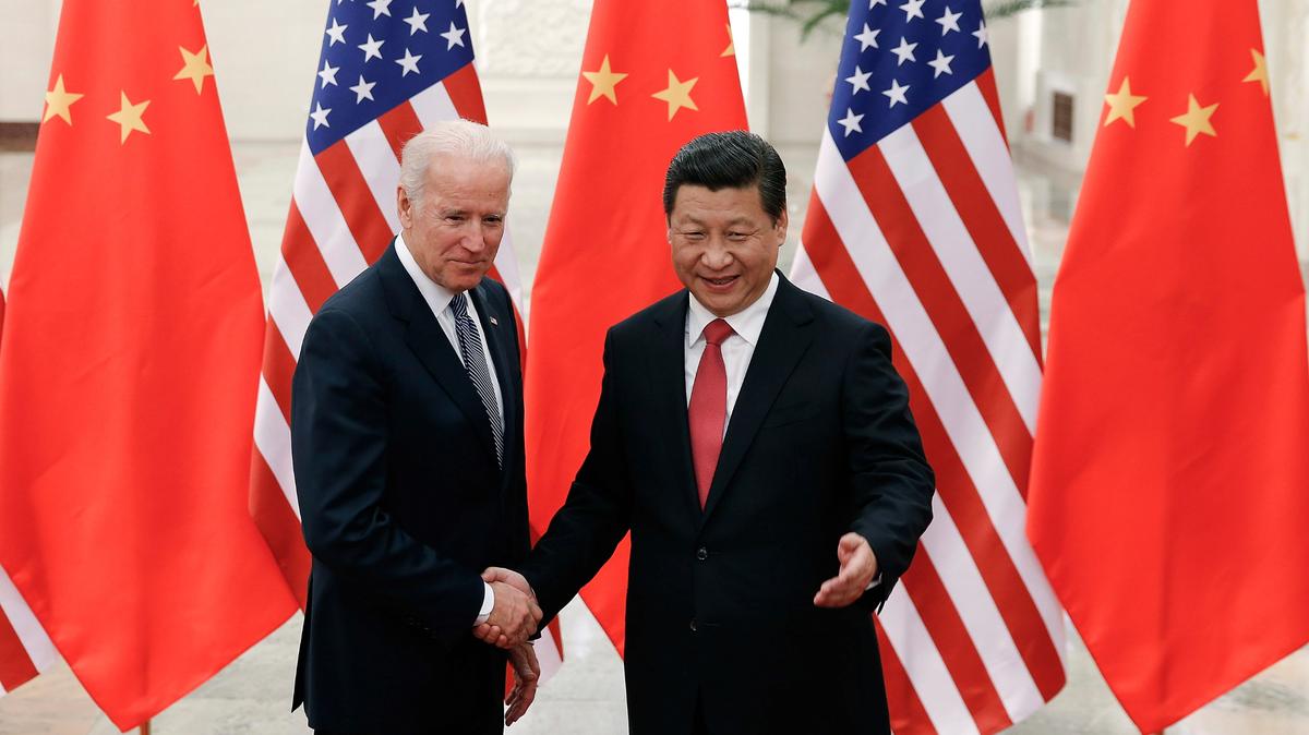 Chinese President Xi Jinping, right, shakes hands with Joe Biden, who was then vice president, as they pose for photos at the Great Hall of the People in Beijing, Dec. 4, 2013.