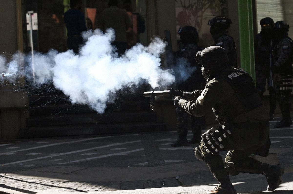 A riot police officer fires a tear gas canister during a protest against Bolivian President Rodrigo Paz's government amid an ongoing economic and fuel crisis, in La Paz, Bolivia, May 14, 2026. REUTERS/Claudia Morales