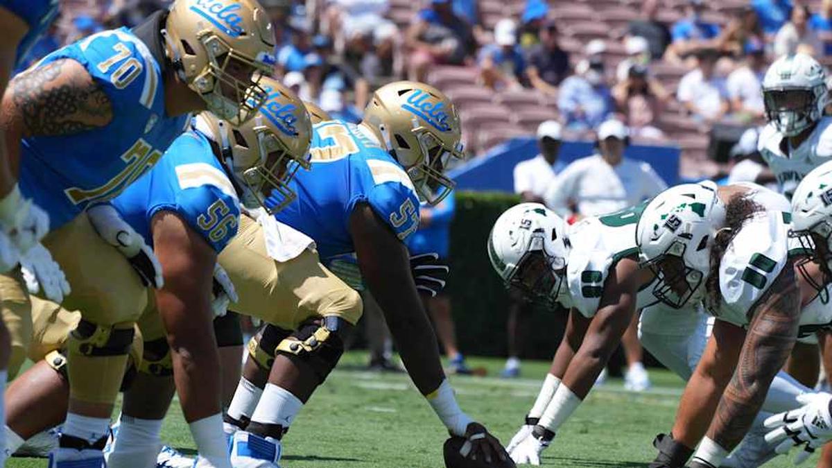  Aug 28, 2021; Pasadena, California, USA; A general overall view of the line of scrimmage as UCLA Bruins offensive lineman Jon Gaines II (57) snaps the ball against the Hawaii Rainbow Warriors at Rose Bowl. Mandatory Credit: Kirby Lee-Imagn Images | Kirby Lee-Imagn Images 